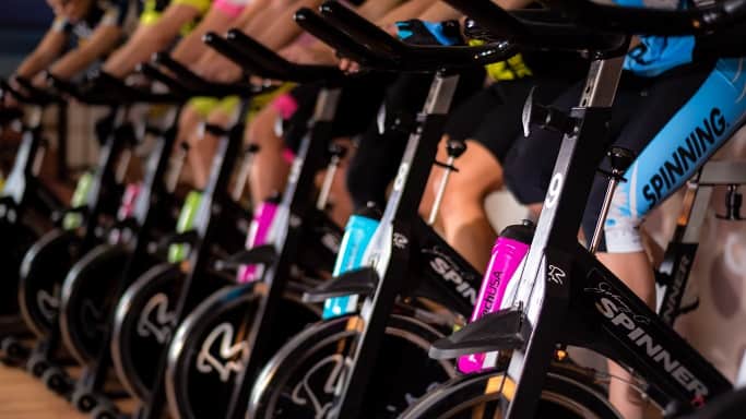 Spinning training on a stationary bike, focusing on building cardiovascular endurance and leg strength. This exercise is a recommended form of cross-training for runners, helping to improve aerobic fitness while giving the running muscles time to recover.