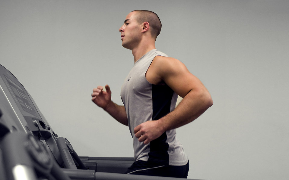 Man running on a treadmill with correct posture and without leaning forward